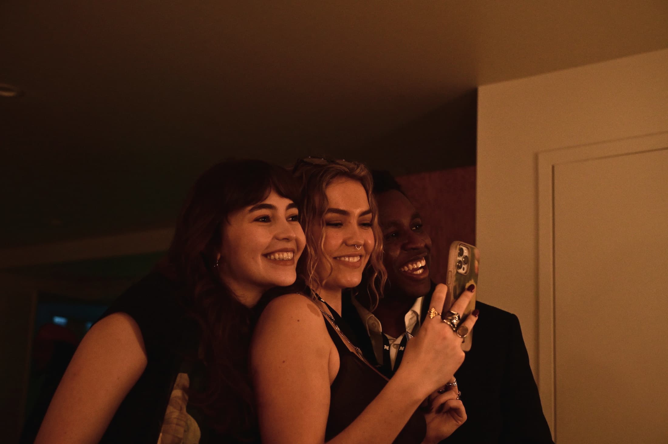 The team huddled around a phone taking a selfie