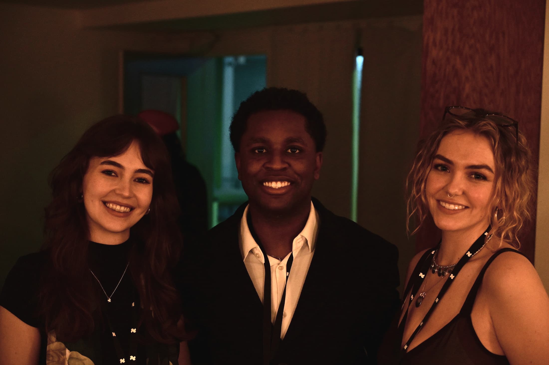 Eli, Abby, and Kaylee — the Nynth team — smiling together at an event